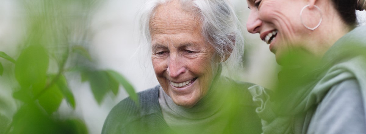 Senior and a younger woman laughing